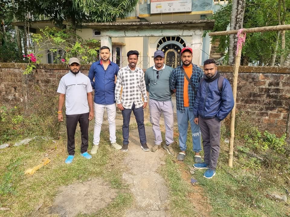 Six local team members posing together outside an outreach location.